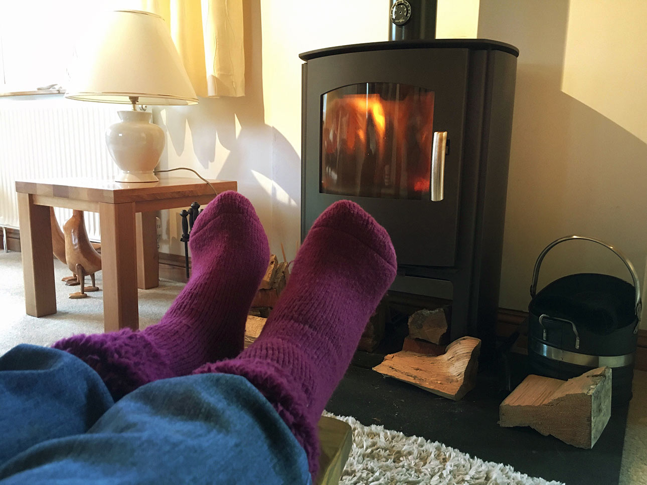 Feet warming in front of a stove
